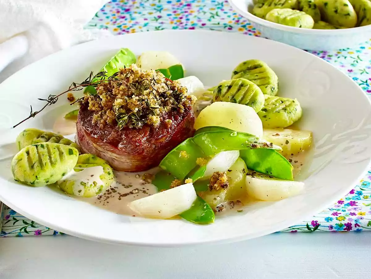 Beef filet steak with pepper crust with wild garlic gnocchi and fine vegetables