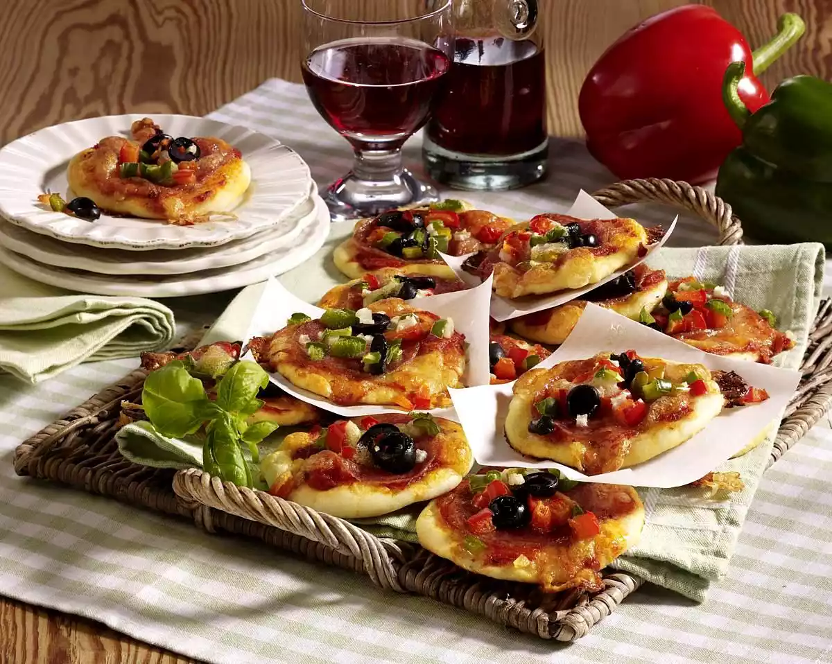 Spicy mini pizzas with salami and paprika