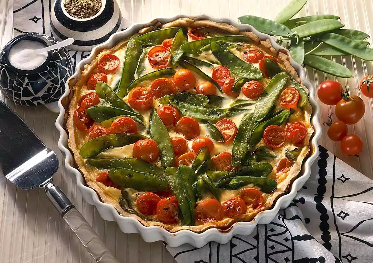 Vegetable quiche with sugar peas and cherry tomatoes
